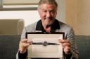 Sylvester Stallone with one of his watches being auctioned (Sotheby’s/PA)