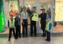 1st Halesowen Scout Group members with Beaver leader Cathy Field (left) being presented with the vests by Lorraine Chew (right) of the Specsavers’ store.