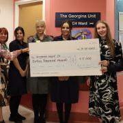 Staff from M&S hand over a cheque to Diane Wake, chief executive at the Dudley Group NHS Foundation Trust, left.