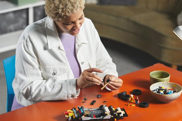 Halesowen News: A woman putting together the LEGO Delorean. Credit: LEGO