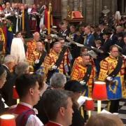 Philip Tibbetts can be seen front right in ceremonial uniform in front of the Queen's coffin