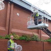 The Christmas lights being installed last year in the town