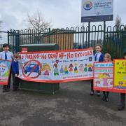 Children at the school with the banners and signs