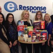 DONATION: Members of the eResponse staff with the start of their food bank collection.