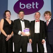 Just2easy picked up the Bett award for Free Digital Content from Caroline Wright, director of BESA, left, and award host and comedian Josh Widdicombe, right.
