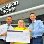 Lex Allan Grove’s Lex Allan and Dean Grove present a cheque to Sunfield’s Georgina Forrest. Photo: Sunfield