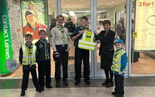 1st Halesowen Scout Group members with Beaver leader Cathy Field (left) being presented with the vests by Lorraine Chew (right) of the Specsavers’ store.