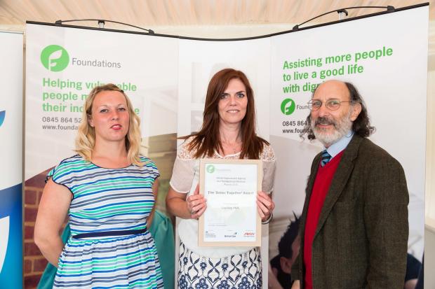 Charlotte Bennett and Helen Langley from Dudley Council's Home Improvement Service receiving the commendation from Carl Petrokofsky, of Public Health England.
